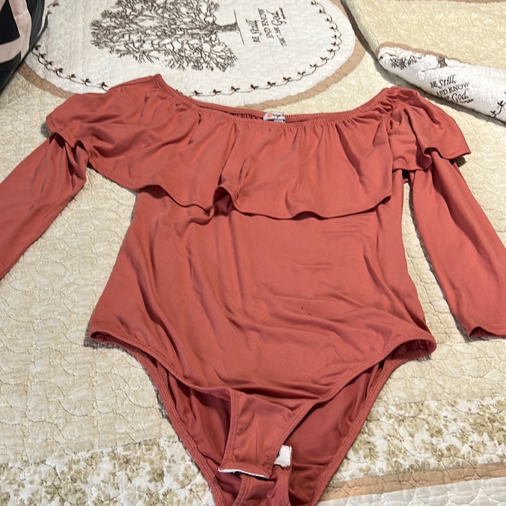 Off the shoulder Ruffle bodysuit brick color.
